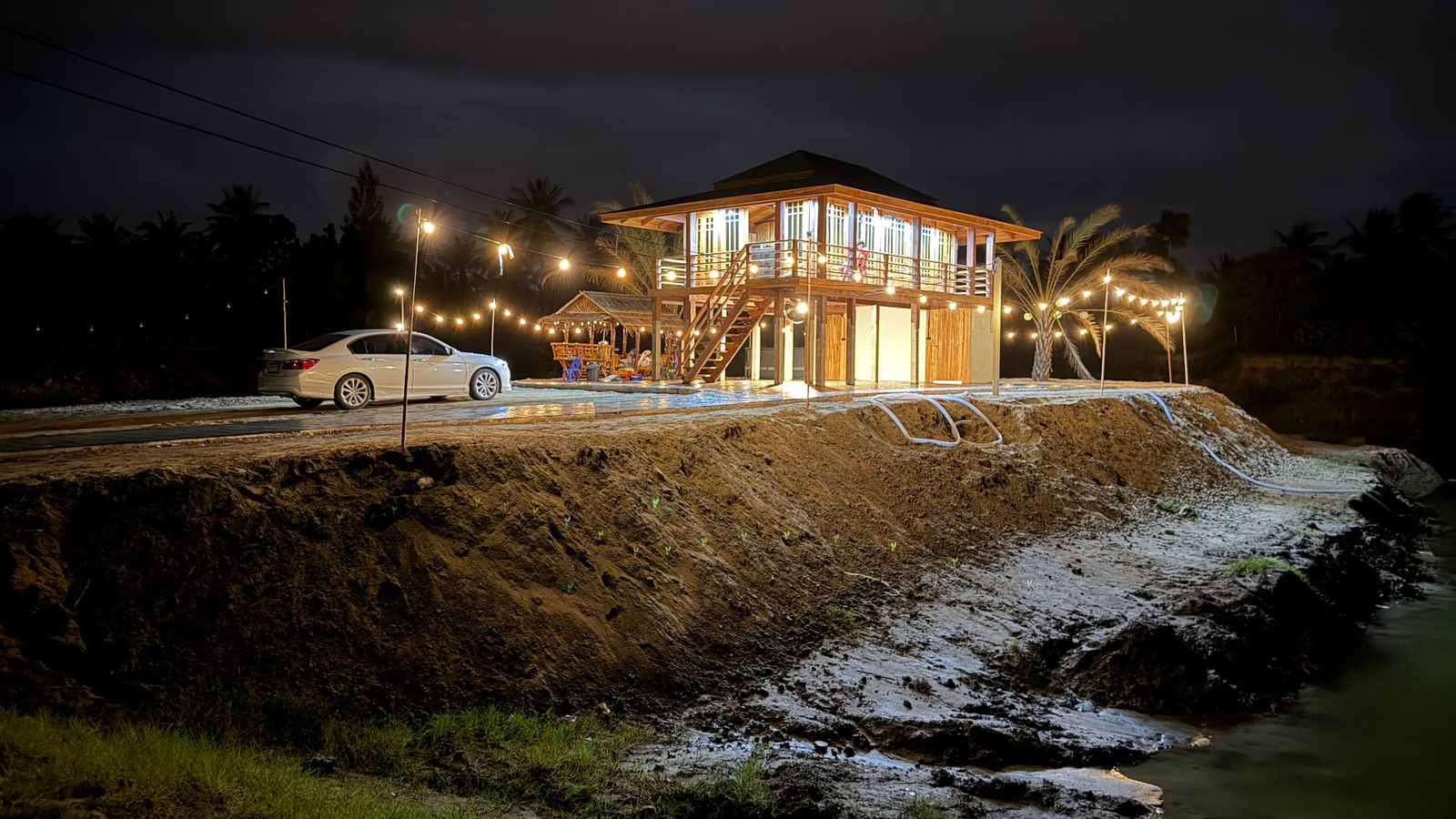 The first house at The Nine lit by warm lights in the evening