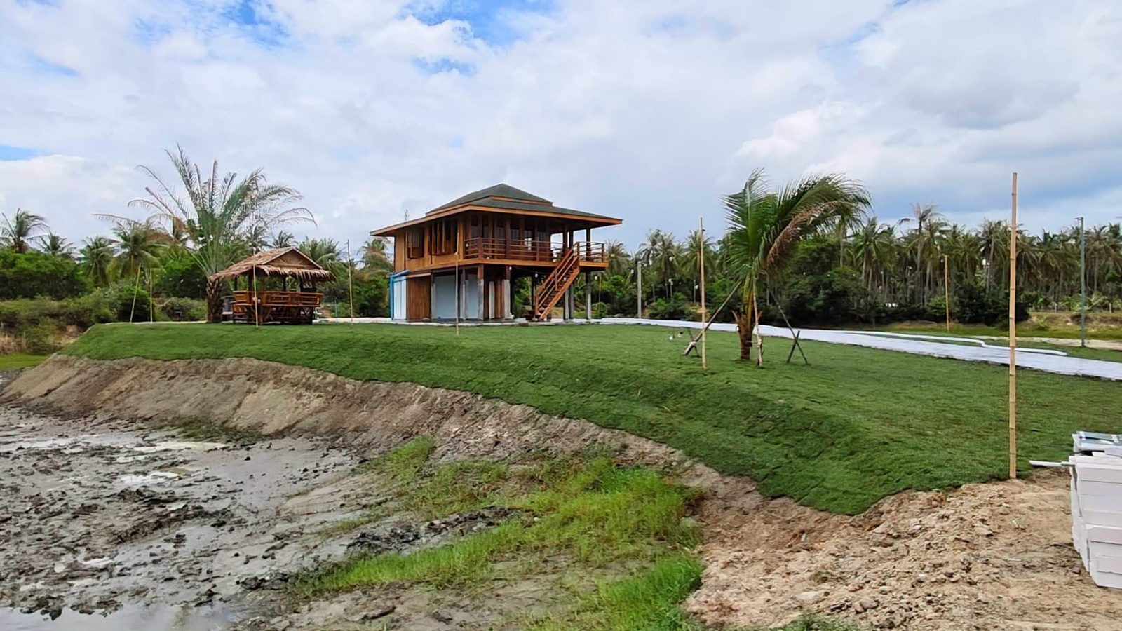 The teak villa of The Nine seen from across the water