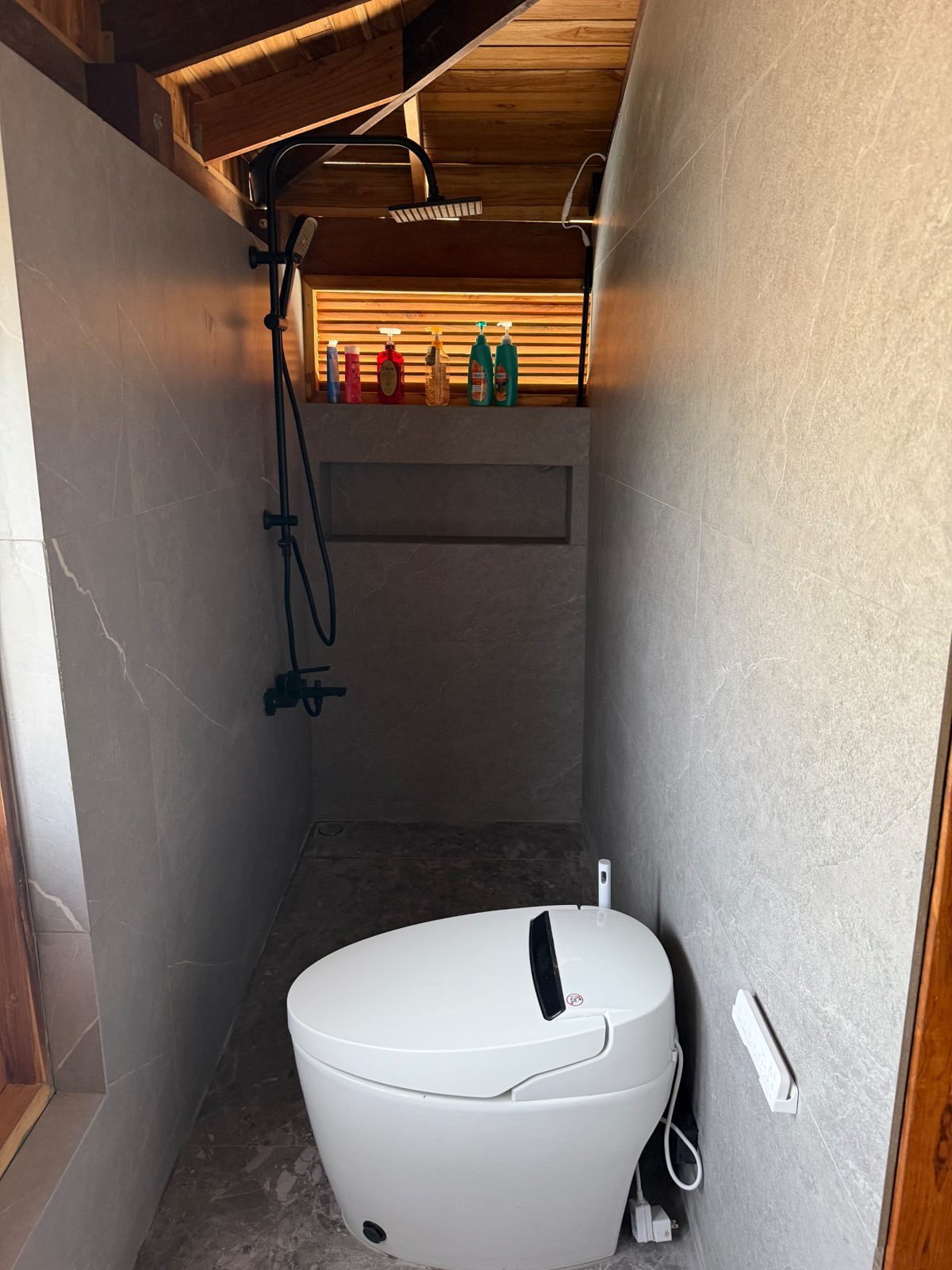 Luxury bathroom at The Nine with rain shower, Japanese smart toilet and natural stone finish