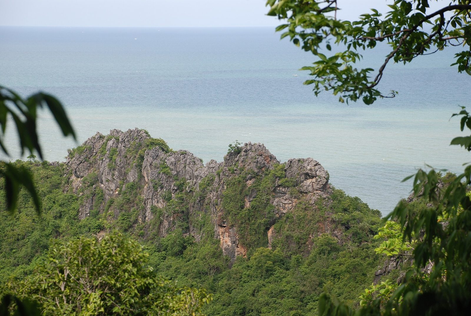 Limestone crags rising above the fields near Kui Buri